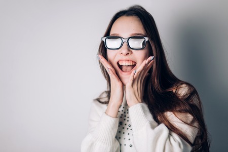 Surprised joyful beautiful woman girl in 3d glasses on white background. virtual reality, cinema, movies, modern technology concept.の写真素材
