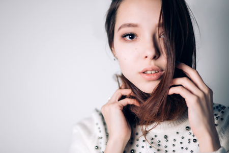 Beauty Woman face Portrait. Beautiful Spa model Girl with Perfect Fresh Clean Skin. female looking at camera. Youth and Skin Care Concept. Isolated on a white backgroundの写真素材