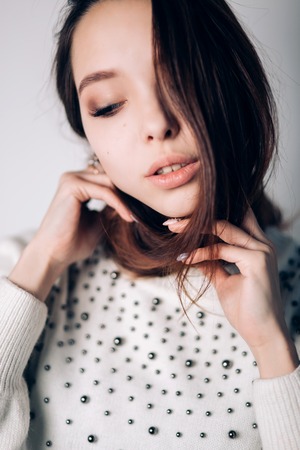 Close up portrait of a serious beautiful woman looking down.の写真素材