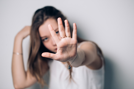 Woman showing stop gesture, on a white backgroundの写真素材