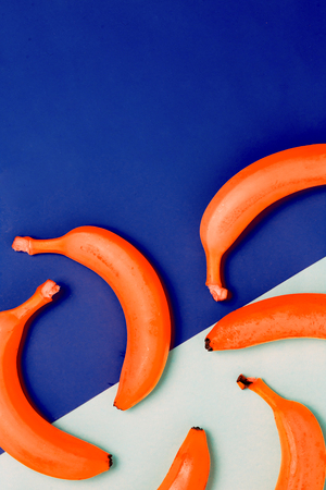 Flat lay of orange banana on a blue background with copy spaceの写真素材