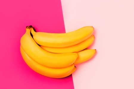 Bunch of bananas on colorful paper backgroundの写真素材