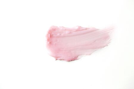 Pink cosmetic product sample isolated on white background. Smear of moisturizing face cream, body...