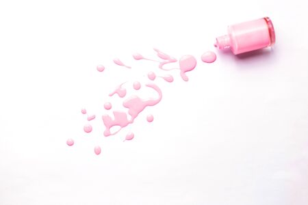 Pink nail polish spilled on white background. Sample of nail varnish. Manicure, pedicure, cosmetics concept. Copy space for text.の写真素材