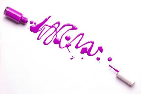 Purple nail polish flowing from the bottle on white background. Nail varnish with splatters and drops. Copy space for text. Manicure, pedicure, cosmetics concept.の写真素材