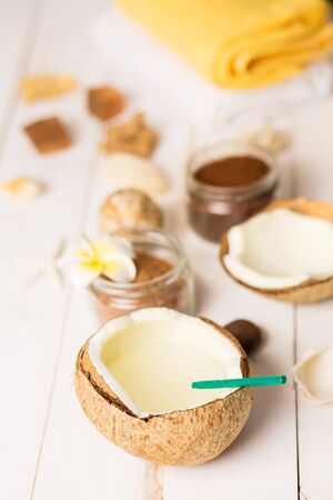 Closeup of fresh exotic coconut cocktail, milk with green drinking straw. Copy space. Spa treatments, relaxation, summer, travel and vacation concept.の写真素材
