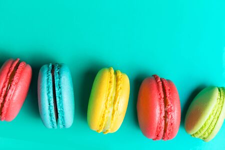 Beautiful fresh macaroon on turquoise background with copy space. Closeupの写真素材