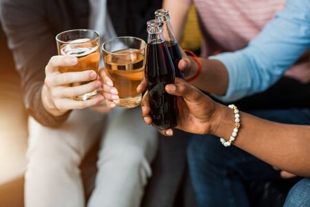 Cropped image of friends clinking bottles and glasses of beer. Leisure, celebration, drinks, people and holidays concept.の写真素材