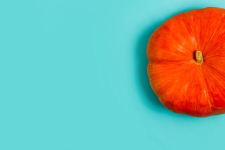 Little orange pumpkins on blue background with copy space for text., top viewの写真素材