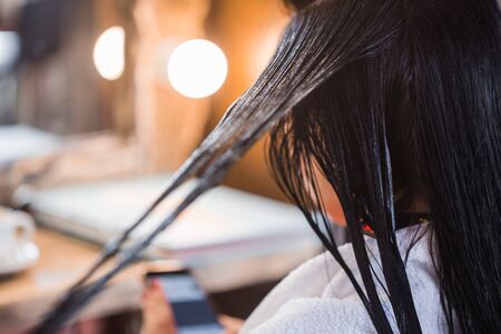 Hair care in modern spa salon. Close up of beautiful woman hair. Mask, balm, hair conditionerの写真素材