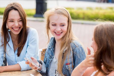 Best friends relax in the Park, laugh and rejoice. Emotions, happinessの写真素材
