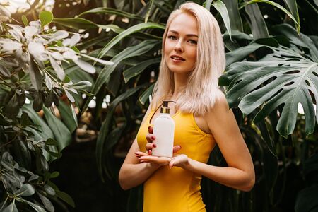 Beautiful woman holding beauty productの写真素材