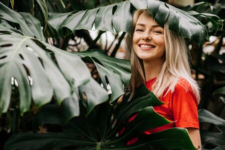 Blonde woman in tropical forestの写真素材