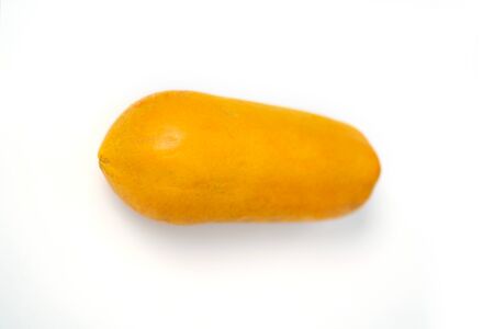 Delicious ripe fresh yellow papaya isolated on white background. One whole papaya fruit. Exotic fruits.の写真素材