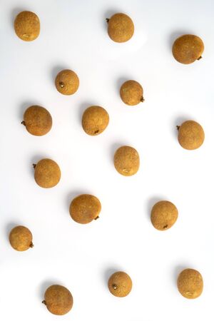 Fresh whole longan fruits isolated on white background. Top view. Flat lay of exotic asian fruits.の写真素材