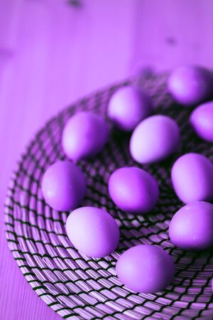 Raw fresh purple chicken eggs on rustic wooden table. Selective focus. Organic food, healthy eating, dieting, protein, farm products concept. Copy space.の写真素材