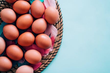Closeup view from above lots of eggs on a blue pastel background with copy space. Happy Easter, food, spring, holiday conceptの写真素材