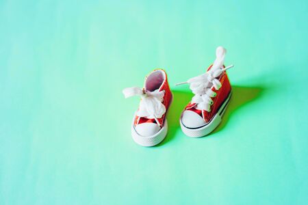 Miniature sneakers isolated on color backgroundの写真素材