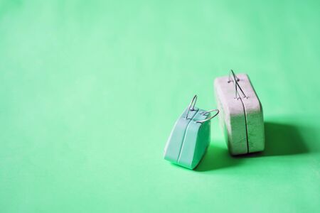 Miniature suitcases isolated on color backgroundの写真素材