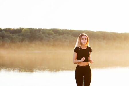 runs in the background of nature. Sports, health, youth conceptの写真素材
