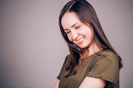 A very happy woman laughs with her eyes closed. Happiness, laughter, smile, emotion conceptの写真素材
