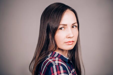 Horizontal close up portrait of a beautiful young woman looking at the cameraの写真素材