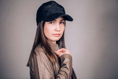 Portrait of beautiful woman on grey background looking at the cameraの写真素材