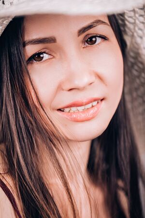 Close-up portrait of a beautiful woman in a hat. natural lips girls, clean skin, Spaの写真素材