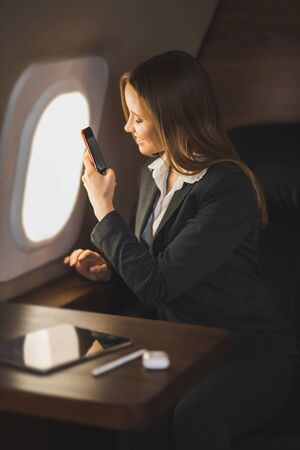 Attractive woman in private jetの写真素材