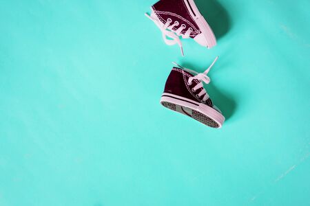 Miniature sneakers isolated on color backgroundの写真素材