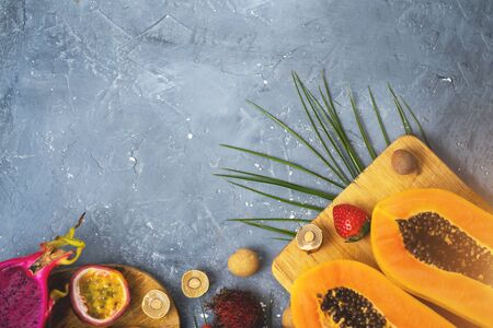 Exotic fruits on wooden chopping boardの写真素材