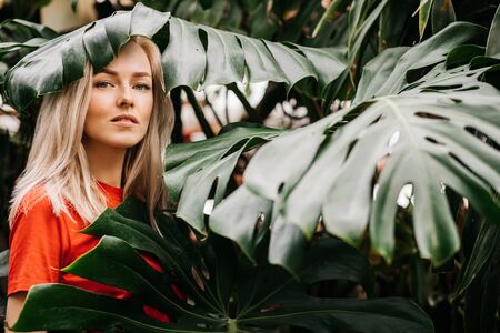 Blonde woman in tropical forestの写真素材