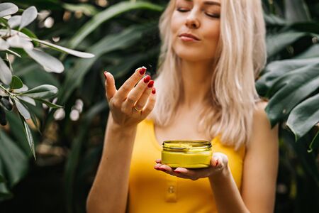 Beautiful woman holding beauty product