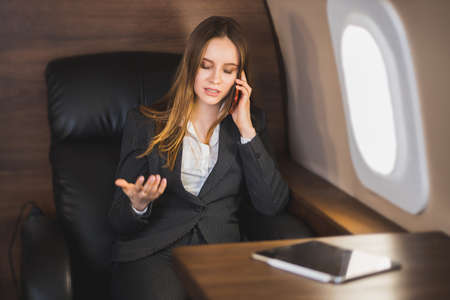 Attractive woman in private jetの写真素材