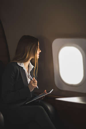Attractive woman in private jetの写真素材