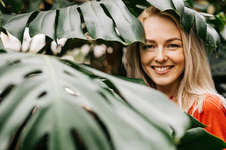 Blonde woman in tropical forestの写真素材