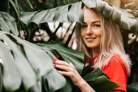 Blonde woman in tropical forestの写真素材