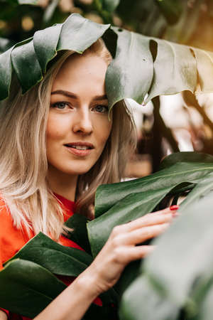 Blonde woman in tropical forestの写真素材