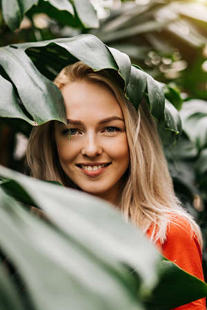Blonde woman in tropical forestの写真素材