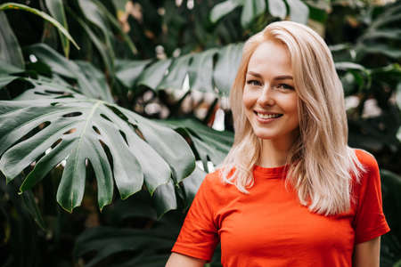 Blonde woman in tropical forestの写真素材