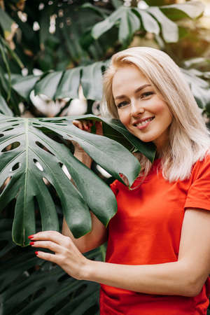 Blonde woman in tropical forestの写真素材