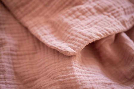 Beautiful pink muslin plaid, blanket, fabric closeupの写真素材