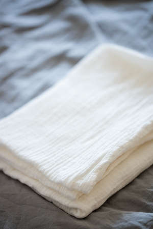 Beautiful white muslin fabric on a gray background. Fabric, textiles, clothing conceptsの写真素材