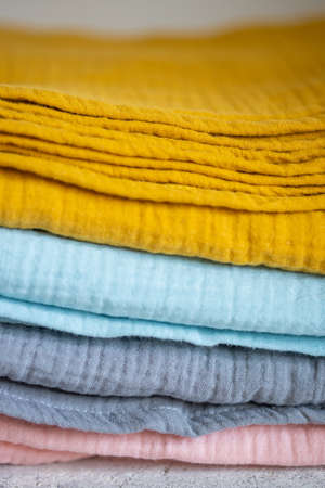 Beautiful pile of fabrics on the tableの写真素材