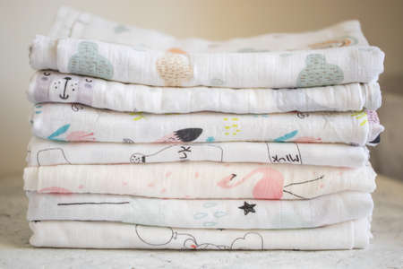 Fabric, textiles, clothing concepts. Multicolored muslin fabric on the table closeupの写真素材