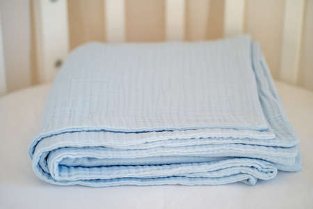 Closeup of a beautiful blue baby blanket on a white backgroundの写真素材