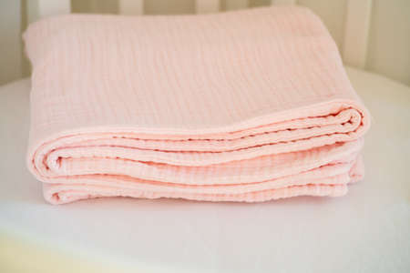 Closeup of a beautiful pink baby blanket on a white backgroundの写真素材