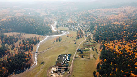 The beautiful countryside in the wild among the mountains, trees in the fall. Nature reserve, protected area. Holiday home. Photos from the droneの写真素材