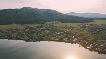 Nature, lake and village under the mountain in summerの写真素材