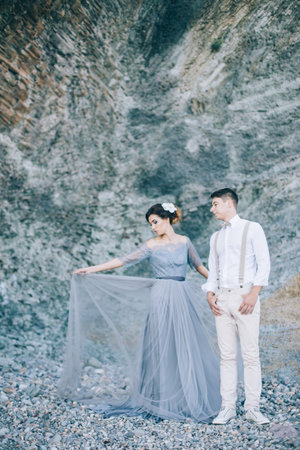 Beautiful couple at the rock. Wedding of youngの写真素材